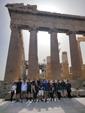 MBA students stand next to the Acropolis in Athens